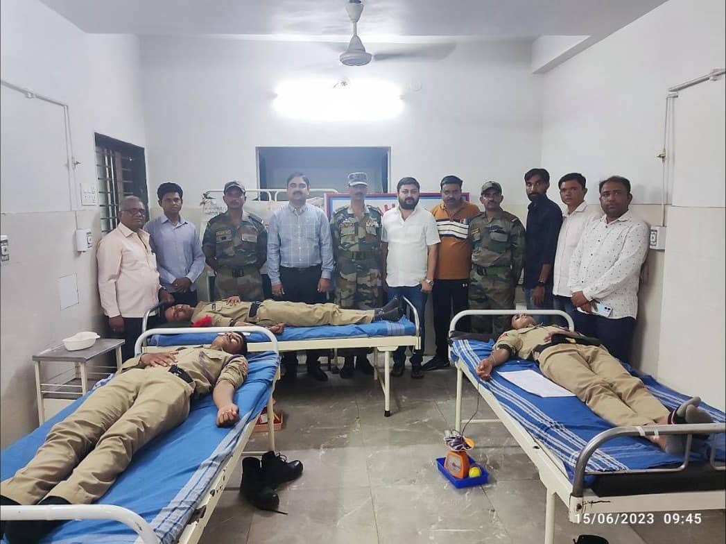 NCC cadets donating blood at the hospital, with doctors and officers standing behind