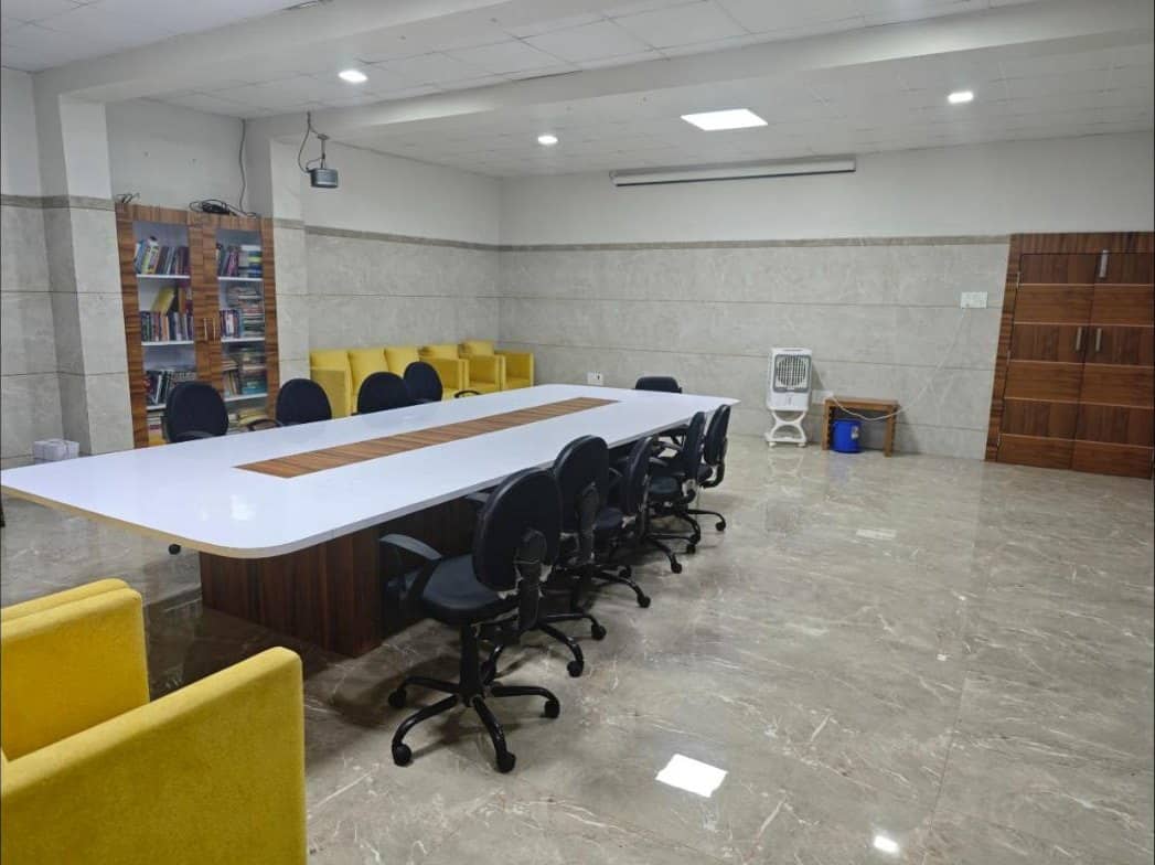 Conference room with long table, chairs and bookshelves
