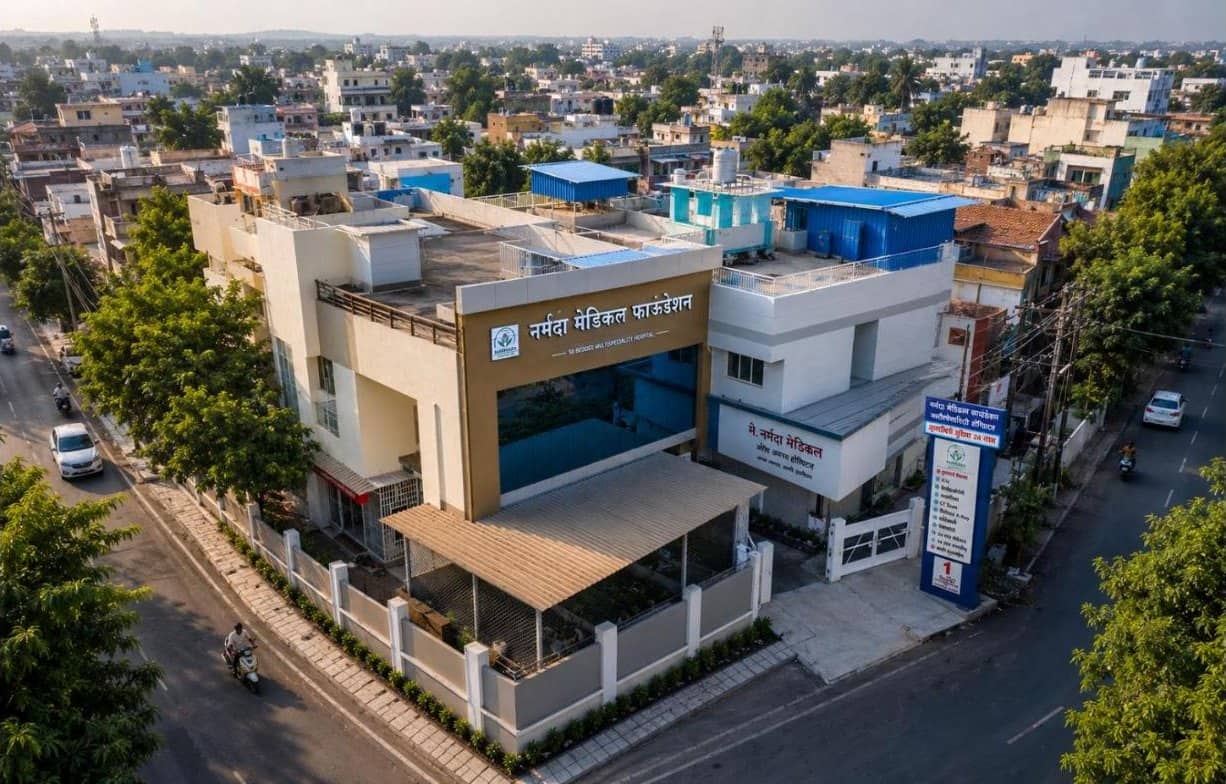 Aerial view of the Narmada Medical Foundation hospital building on Dhule Road, Amalner